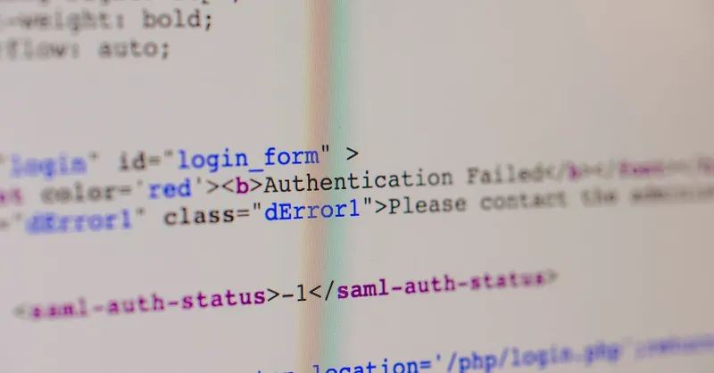 Close-up of HTML and PHP code on screen showing error message and login form data.