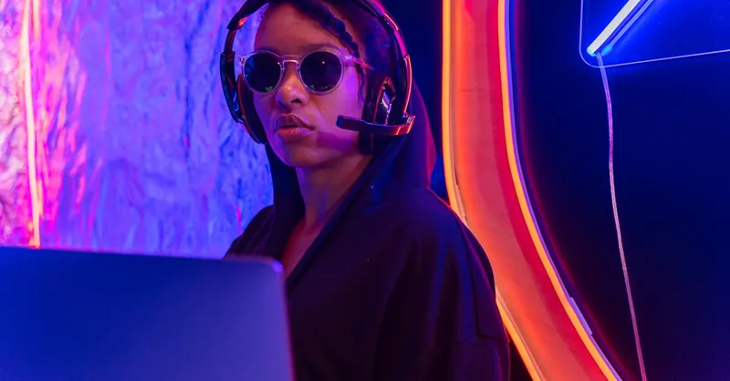 A focused professional in sunglasses and headset monitors cybersecurity in a neon-lit room.