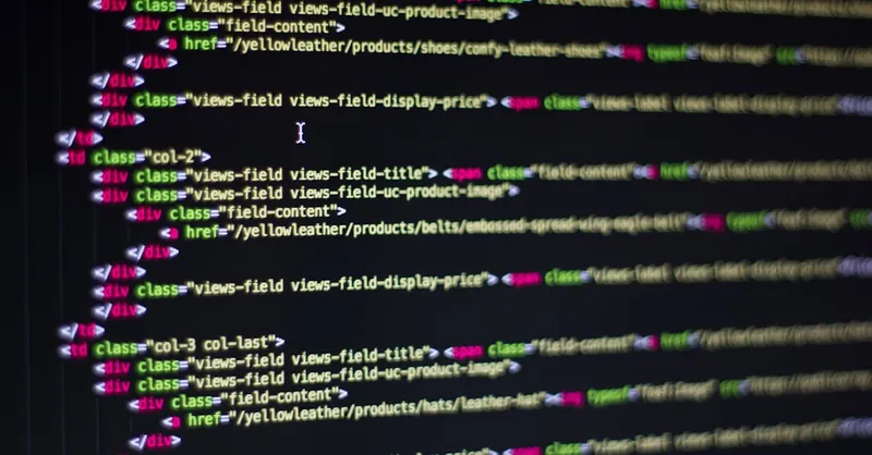 Detailed close-up of HTML code on a computer monitor, showcasing web development.